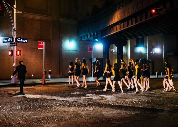 Group of ladies in black dresses on a night out in a city