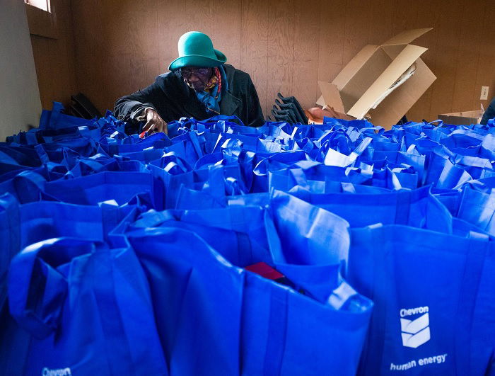 Woman looking in one of many blue bags