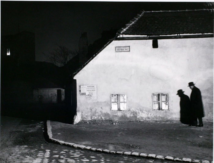 Man walking near wall at night