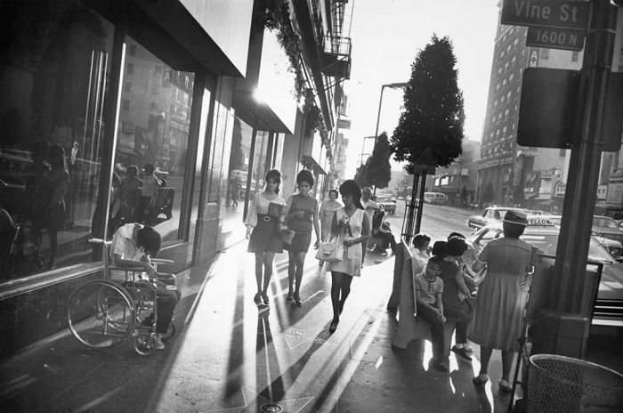 Backlit people walking down NY street