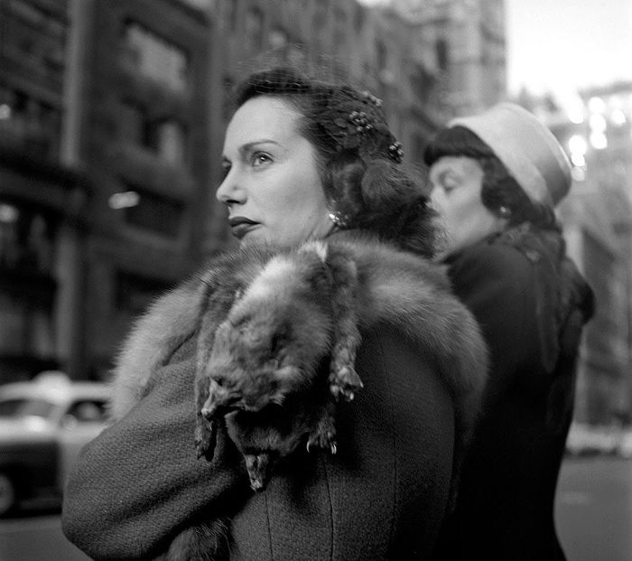 Woman with real fur scarfs on her shoulder