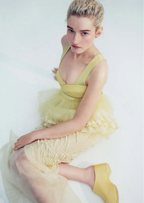 Woman in yellow dress sitting on studio floor