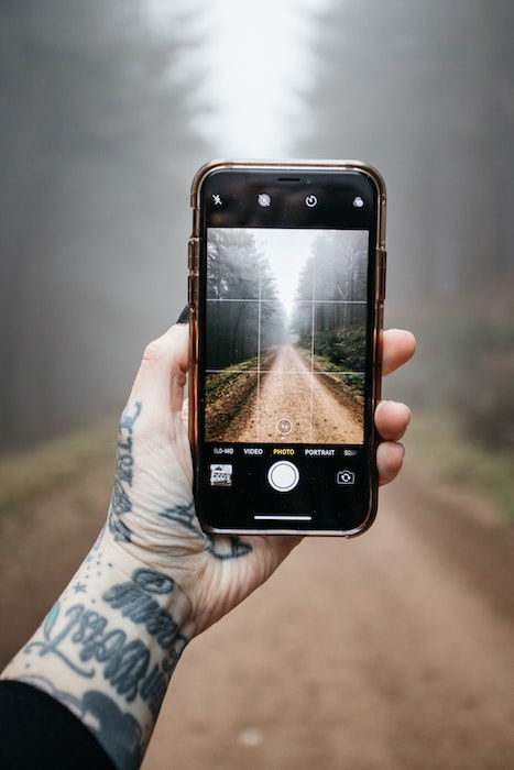 person using a grip to take a photo of a path 