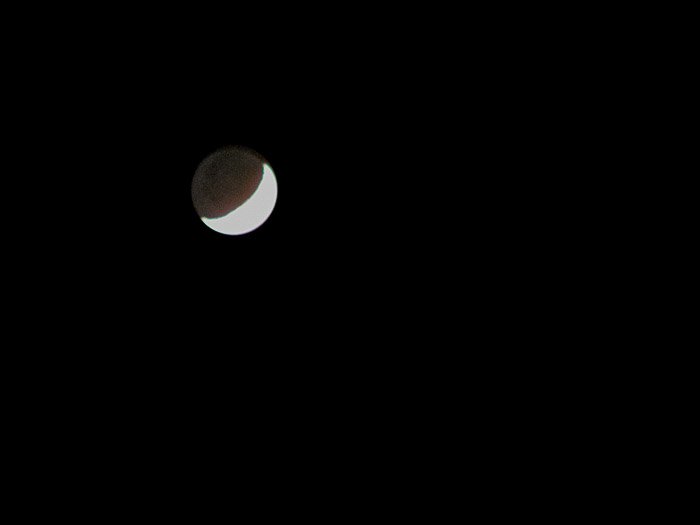 Moon photography shot showing the silhouette of the dark sections illuminated by Earthshine