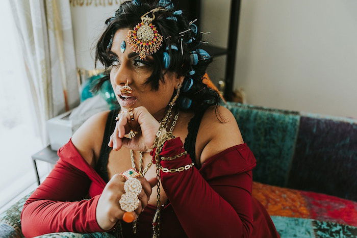 A portrait of a desi woman with intricate jewellery and a nose piercing